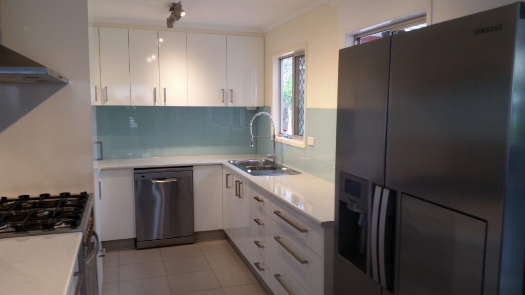 Glossy white melamine kitchen.