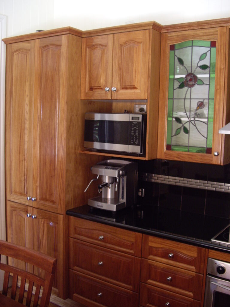 Rosewood Timber kitchen pantry with split doors.