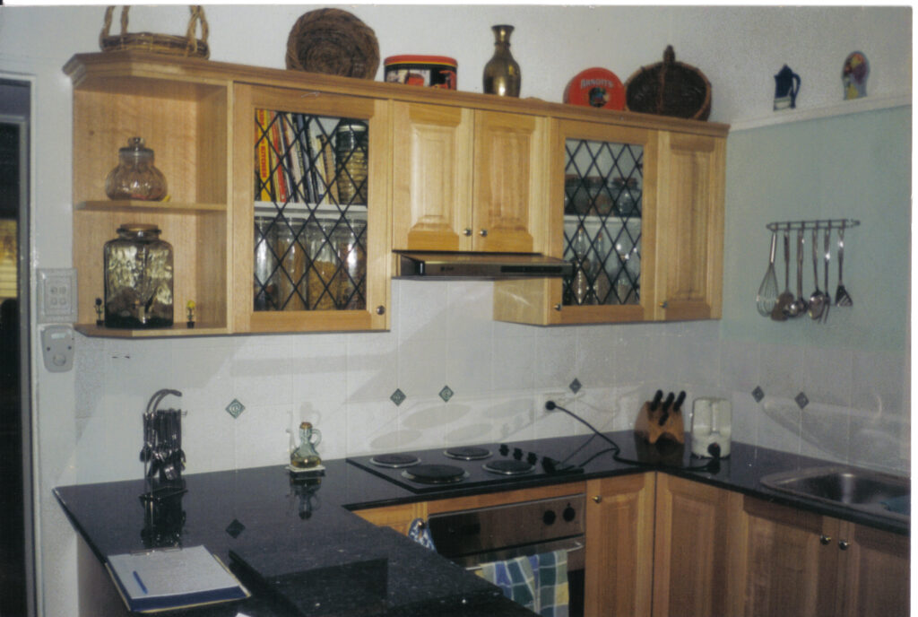 Tasmanian oak doors with Black Galaxy Granite Benchtop with collage wall unit doors