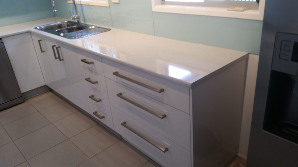 Glossy white melamine kitchen.